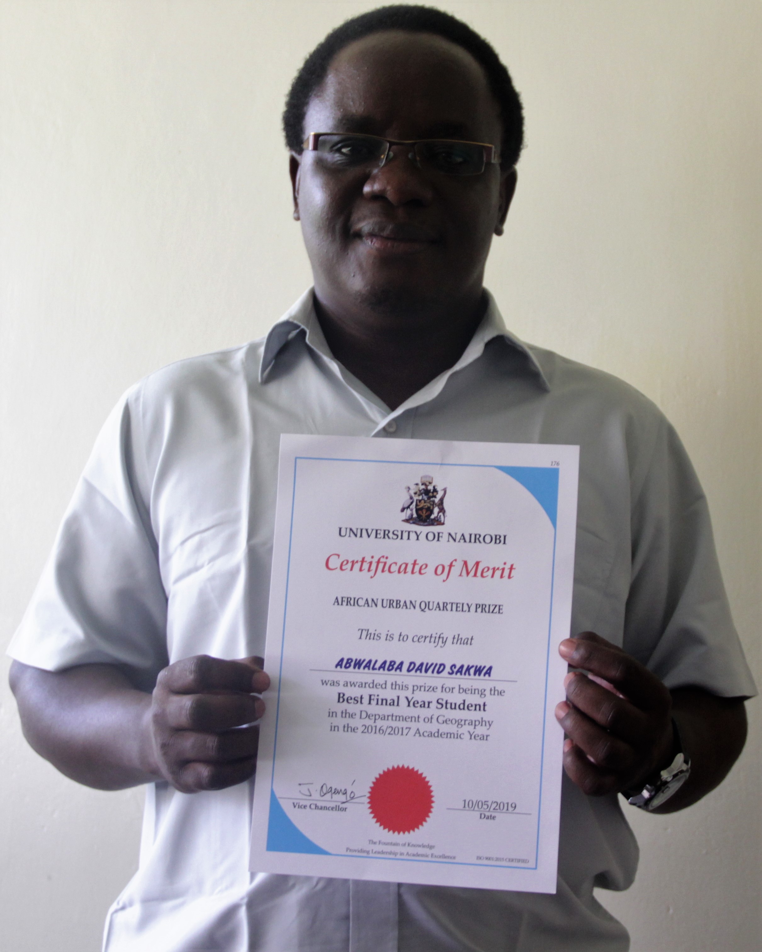 David Sakwa Displays the Certificate Awarded to him 